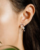 round rose gold plated earrings with crystals and pearls made with swarovski elements on ear from forest jewelry singapore