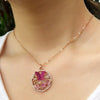 necklace pendant in rose gold plating with butterfly and flowers garden in pink and clear crystals from forest jewelry on neck