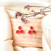 a pair of trillium spring flowers stud earrings made with leather in cherry red set in yellow gold plating from forest jewelry singapore