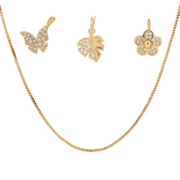 Gold jewelry set with butterfly and floral charms on a white background