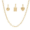 Gold necklace with three shaped charm on a white background