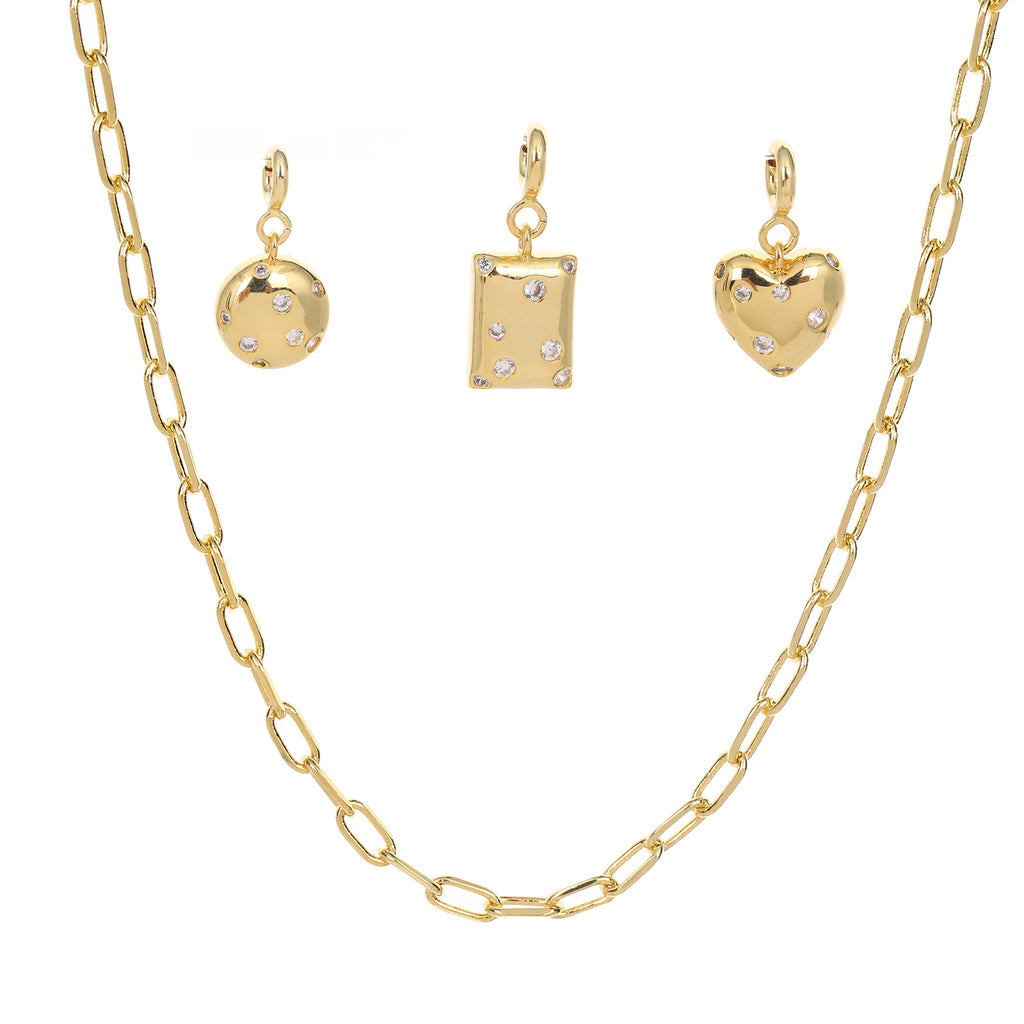 Gold necklace with three shaped charm on a white background