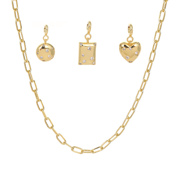 Gold necklace with three shaped charm on a white background