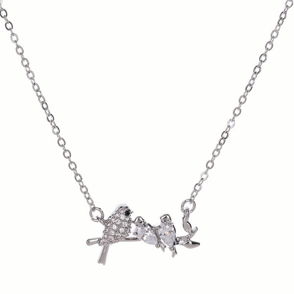 Silver necklace with birds and branch pendant on a white background