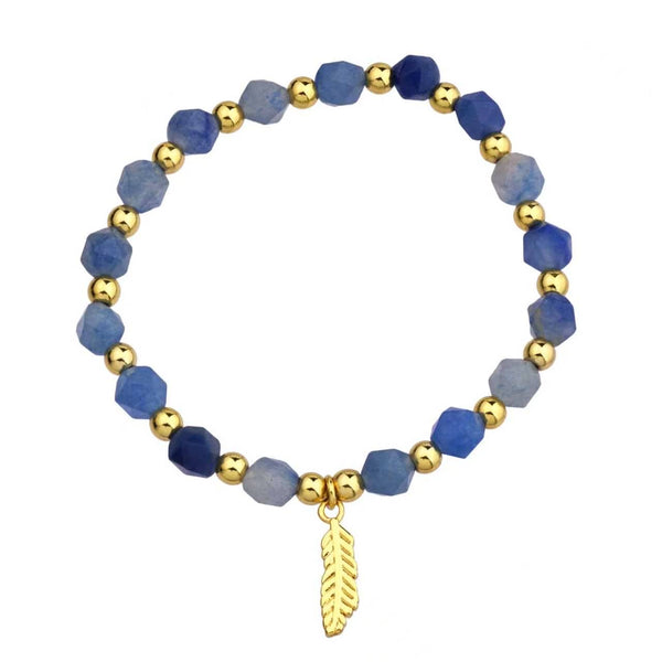 Bracelet with aquamarine and gold beads on a white background
