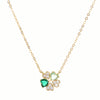 Gold necklace with a clover-shaped pendant featuring green crystals on a white background