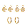 Set of gold huggie hoop earrings including  flower, and hoop designs on a white background