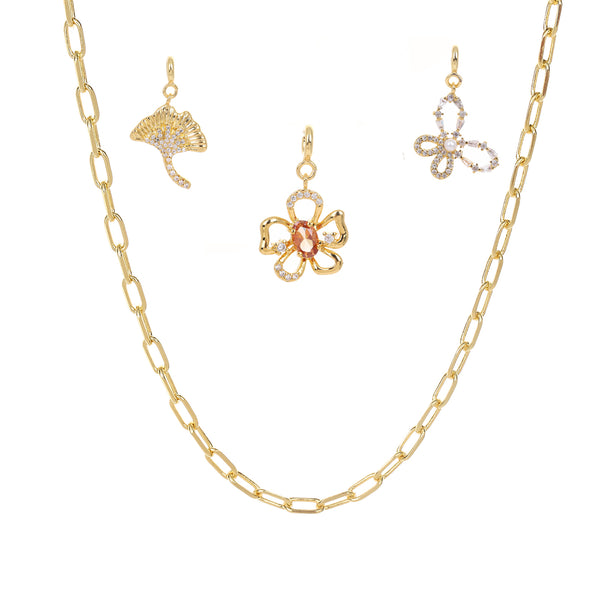Gold chain necklace with butterfly pendants on a white background