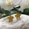 a pair of petite yellow dendrobium orchid stud earrings in rose gold plating on stone from forest jewelry singapore