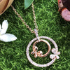 necklace pendant in rose gold plating with butterfly in crystals from forest jewelry on grass