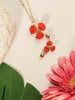 necklace pendant in yellow gold plating with red flower petals from Forest Jewelry singapore on table