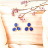 a pair of trillium spring flowers stud earrings made with leather in cobalt blue set in yellow gold plating from forest jewelry singapore