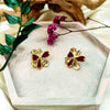 yellow gold plated ear studs with gold and red petals from forest jewelry